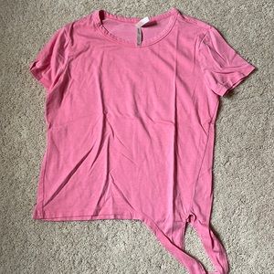 Pink short sleeve shirt with a tie on the front